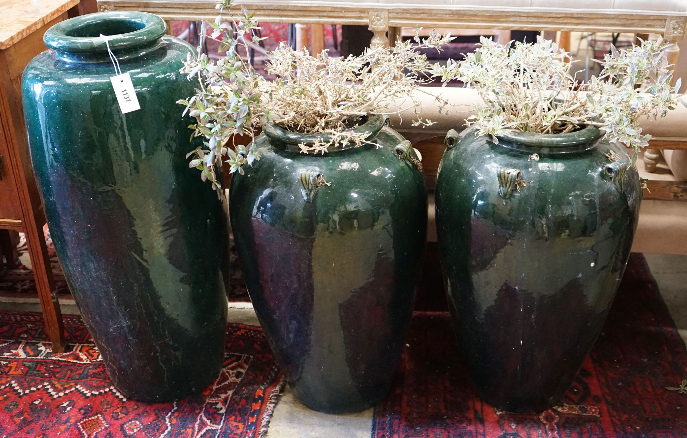 Three (two plus one) green glazed earthenware garden planters, tallest 87cm